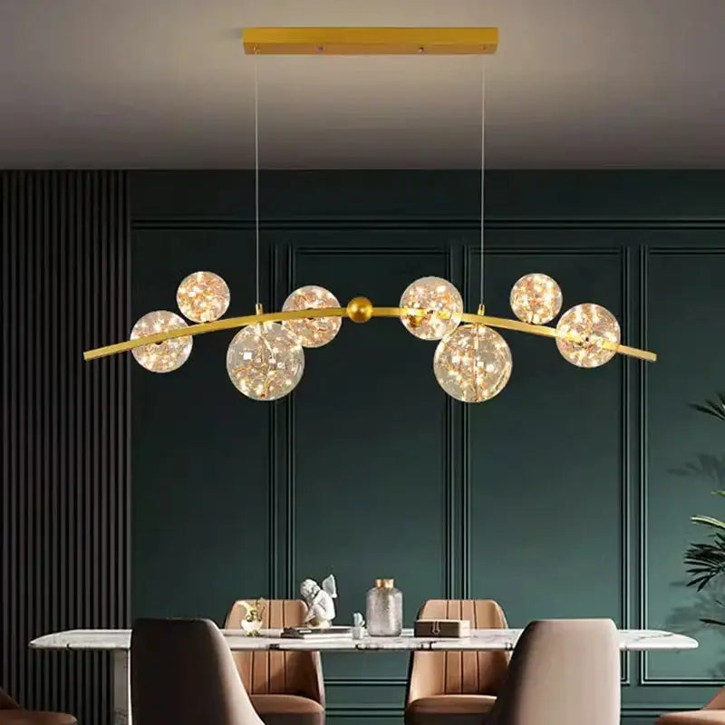 Gold-toned decorbites led pendant light chandelier with curved central bar and spherical glass globes for modern interiors