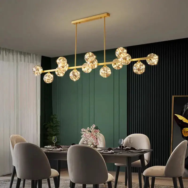 Gold-toned decorbites led pendant light chandelier with spherical glass globes suspended from a sleek bar for modern decor