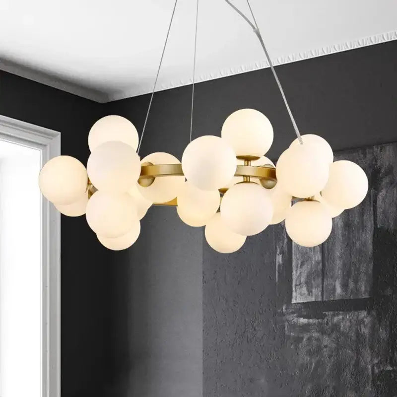 Modern decorbites led pendant light chandelier with frosted glass globe bulbs and brass metal arms for living room lighting