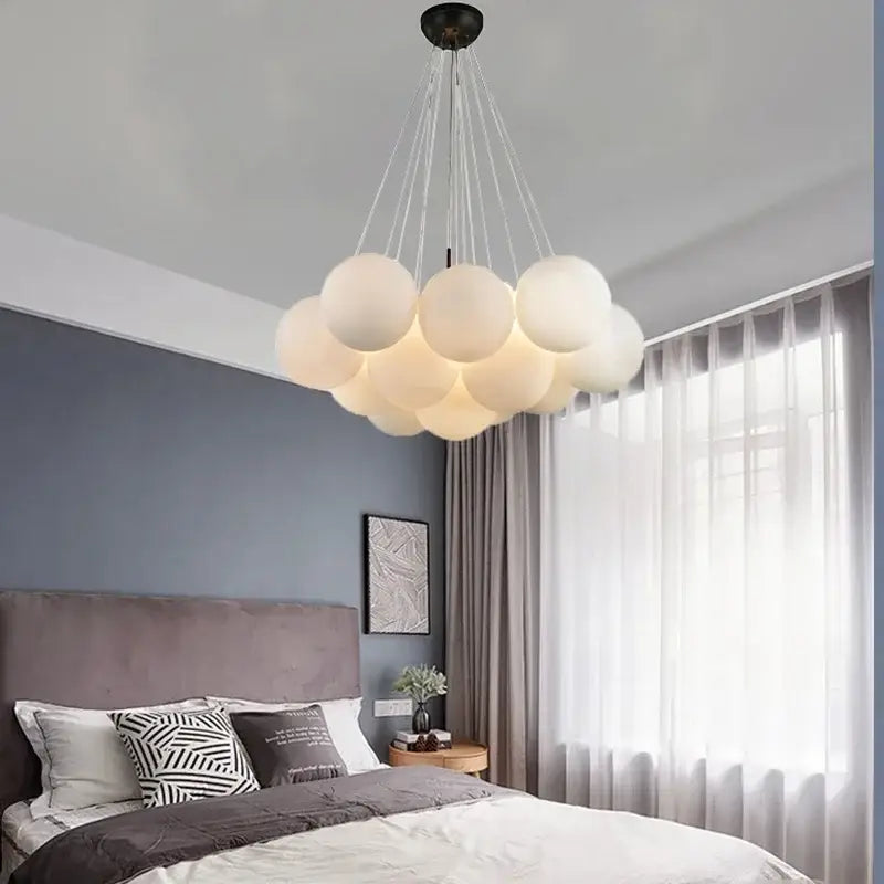 A modern decorbites led pendant light chandelier with frosted white glass bulbs and black ceiling fixture for indoor decor