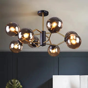 Modern brass and black pendant lights with amber glass globe shades by DecorBites led pendant for dining room lighting