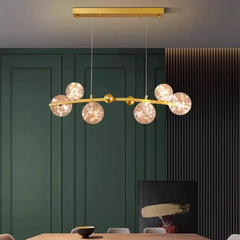 Gold-toned decorbites led pendant light chandelier with six frosted glass globes for modern indoor living spaces