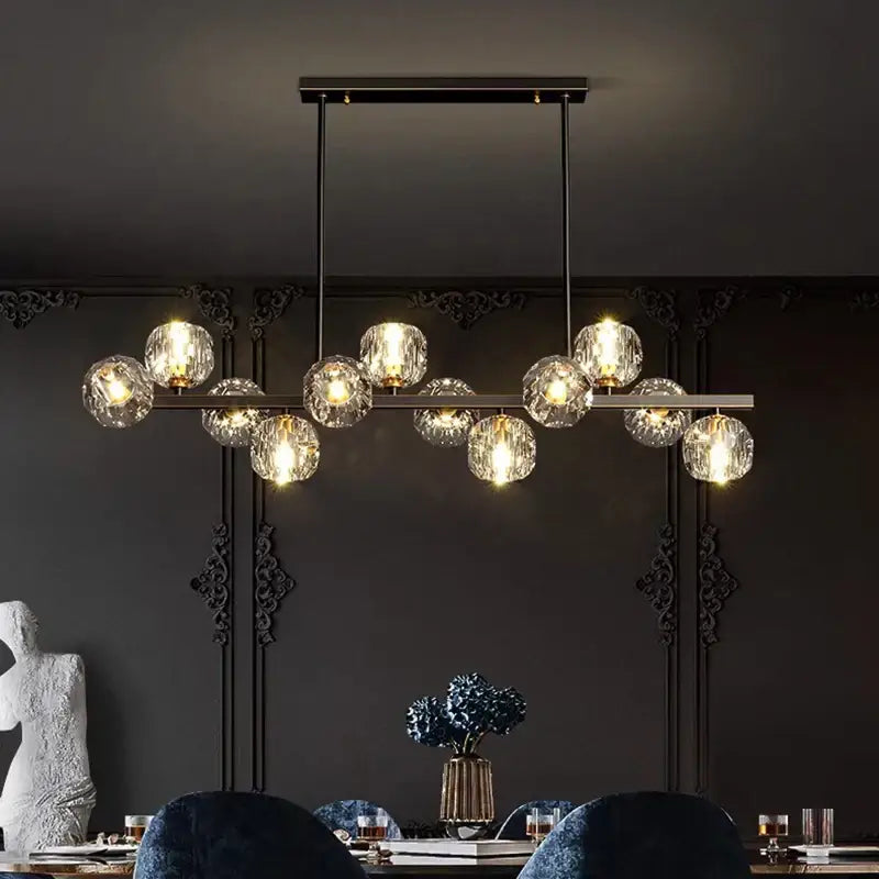 Modern black metal DecorBites LED pendant light chandelier with clear faceted glass globes emitting warm light