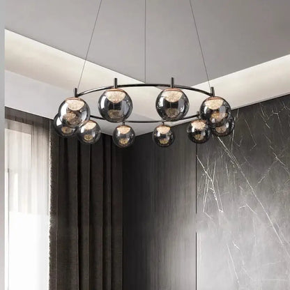 Modern black-framed DecorBites LED pendant light chandelier with reflective glass globe shades for indoor lighting