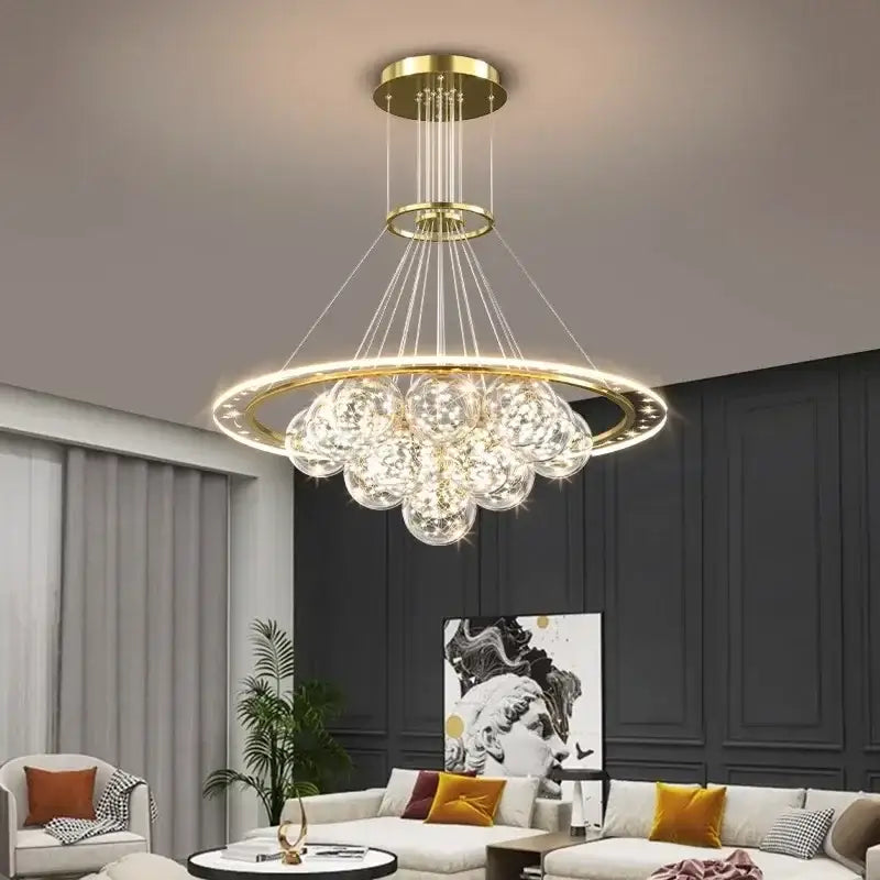 Gold-toned decorbites led pendant chandelier with circular frame and clear crystal spheres for modern indoor lighting