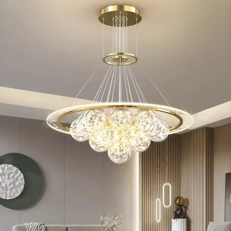 Gold-toned DecorBites LED pendant light chandelier with circular frame and clear glass orbs for modern home decor
