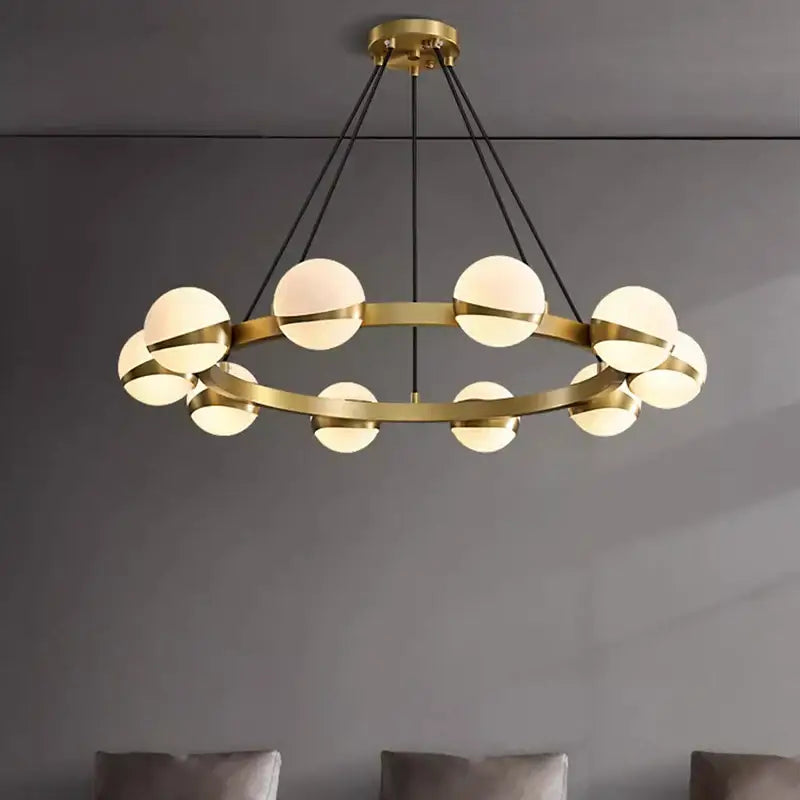 Gold-toned circular DecorBites LED pendant light chandelier with frosted glass globes and black cords for indoor lighting