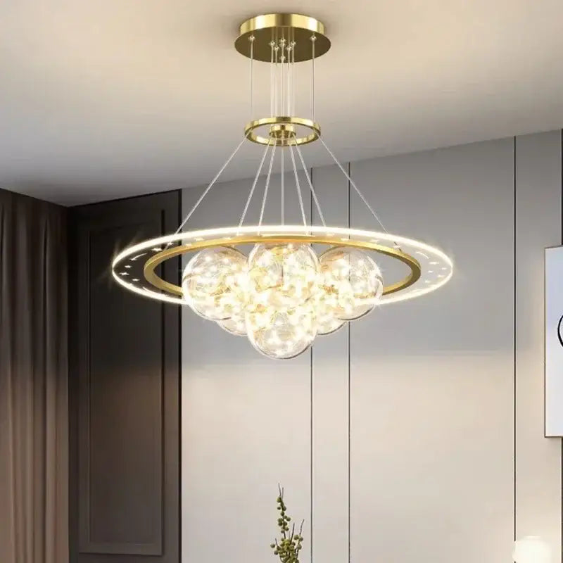Gold-toned DecorBites LED pendant light chandelier with circular frame and clear glass orbs for modern indoor lighting