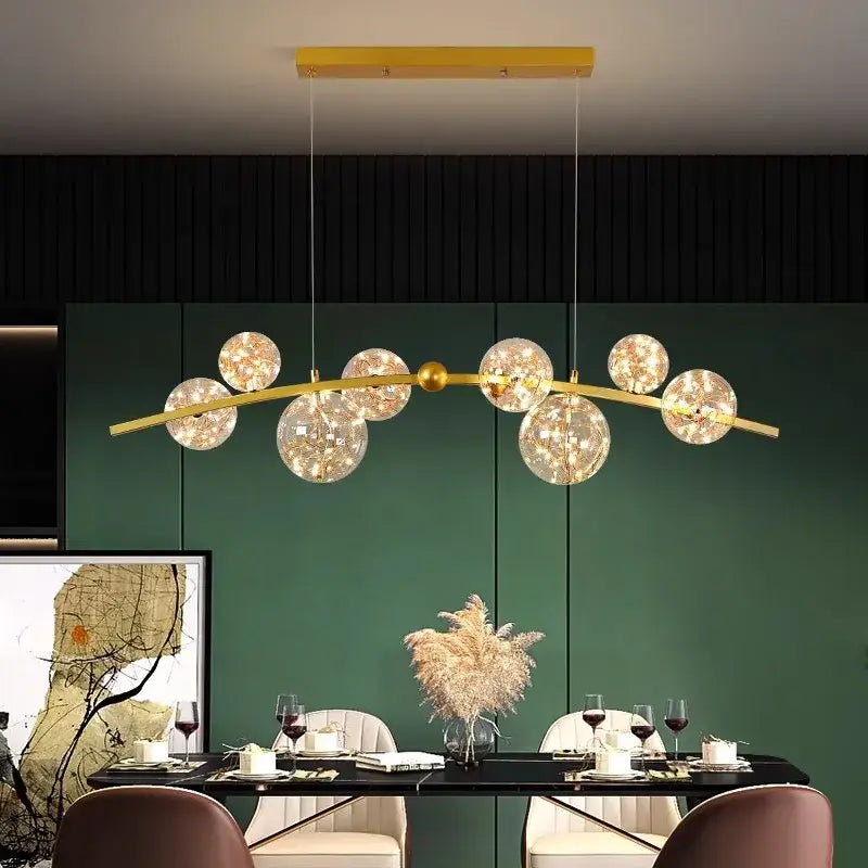 Gold-toned modern decorbites led pendant light chandelier with spherical glass globes for indoor living and dining rooms