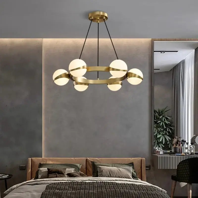 Modern brass DecorBites LED pendant light chandelier with six frosted glass globe lights for indoor lighting decor