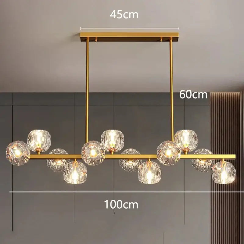 Gold-toned decorbites led pendant light chandelier with faceted crystal globes suspended from a sleek bar