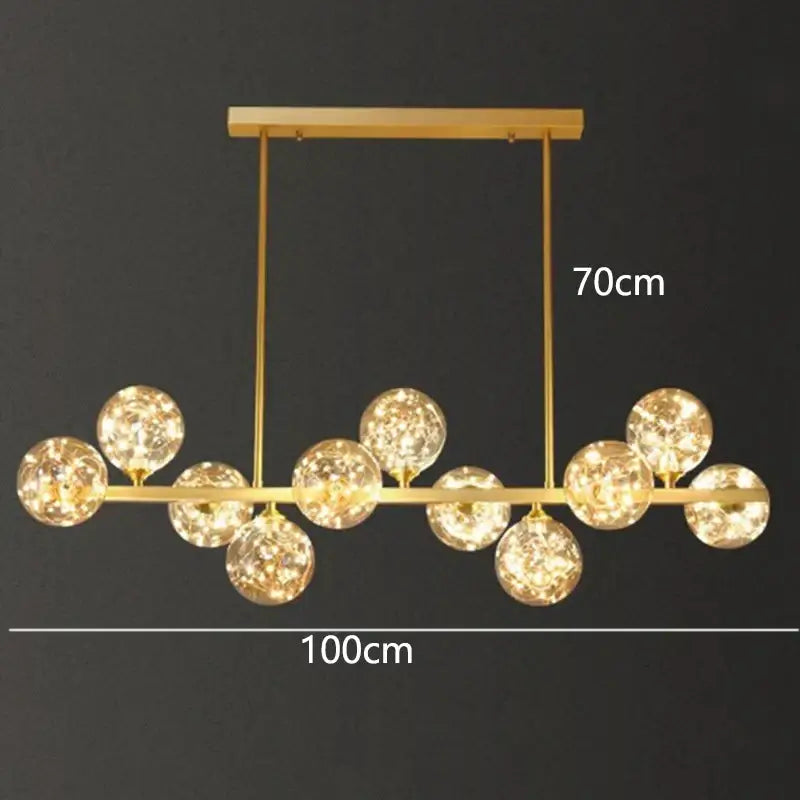 Gold-toned DecorBites LED pendant light chandelier with multiple glass globes emitting warm indoor lighting