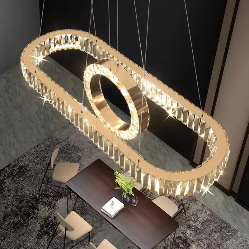 Gold-toned DecorBites LED pendant light chandelier with embedded crystal prisms and central ring for modern decor