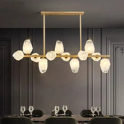 Gold-toned decorbites led pendant light chandelier with faceted translucent glass shades in modern geometric pattern