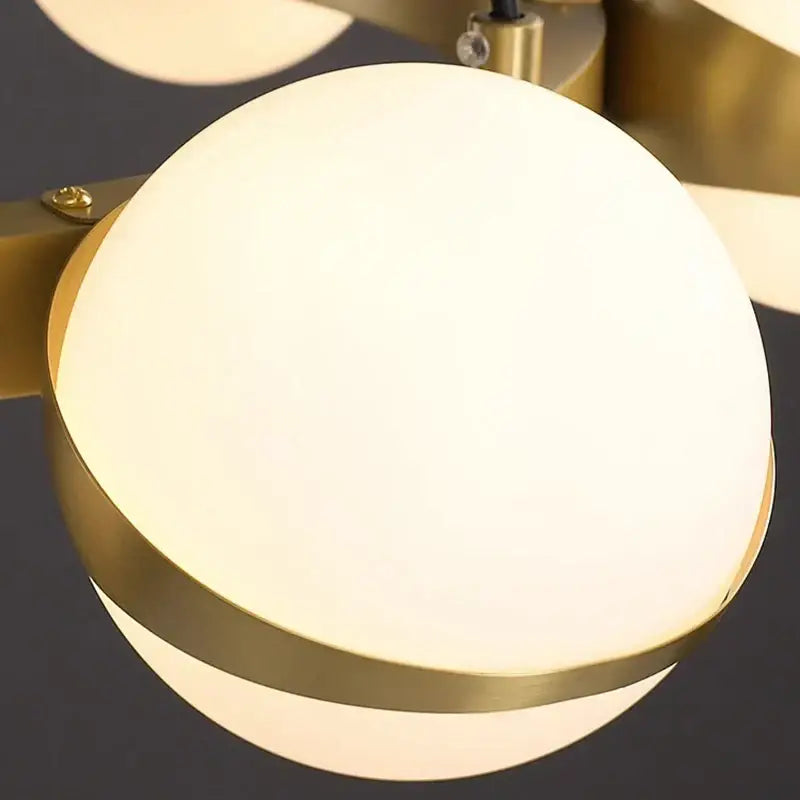 A modern decorbites led pendant light with frosted glass globe and polished brass trim for indoor lighting