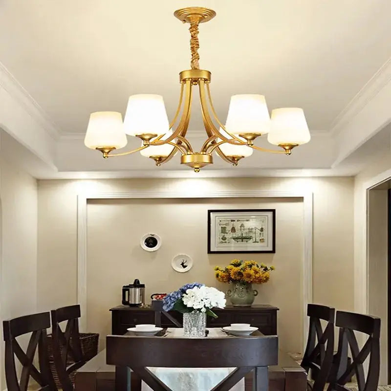 Gold-toned DecorBites led pendant chandelier with six frosted glass shades and ornate twisted metal arms for modern lighting