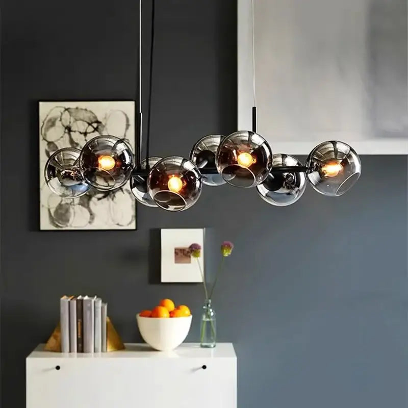 Modern glass globe pendant lights with sleek black metal frame and warm led bulbs by decorbites led pendant light