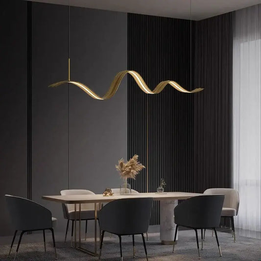 Golden wave-shaped DecorBites LED pendant light with sleek metallic finish hangs above dining table for modern decor