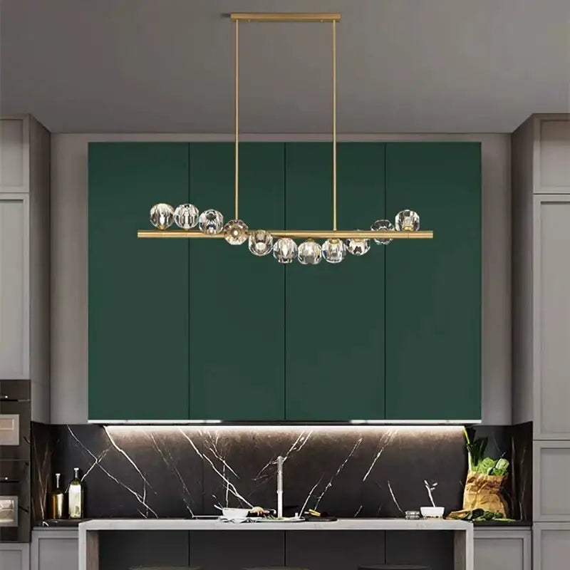 Gold-toned decorbites led pendant light chandelier with clear crystal spheres for modern living and dining rooms