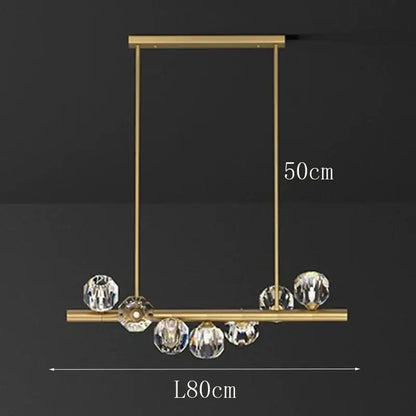 Gold-toned decorbites led pendant light chandelier with rectangular frame and hanging crystal spheres for modern living room lighting