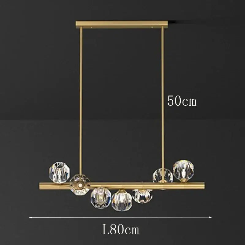 Gold-toned decorbites led pendant light chandelier with rectangular frame and hanging crystal spheres for modern living room lighting