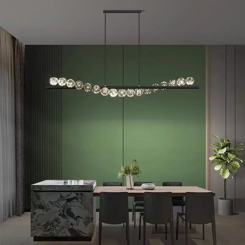 Modern linear DecorBites LED pendant light chandelier with sleek black frame and clear faceted glass spheres for living room