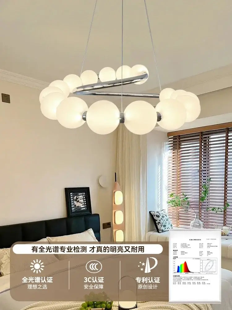 Modern white spherical pendant light chandelier with sleek chrome metal frame for living and dining room decor