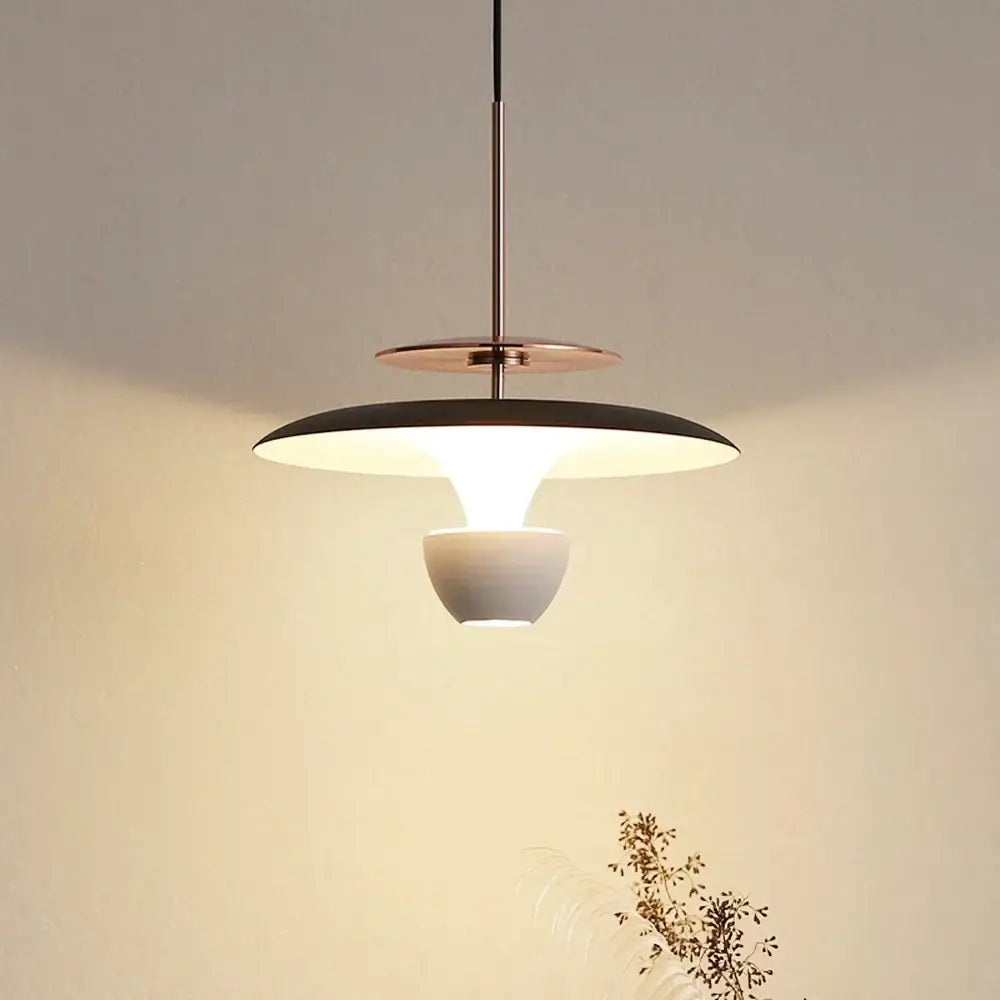 Modern decorbites led pendant light with sleek black and matte white ceramic tiers suspended by copper rod for dining room