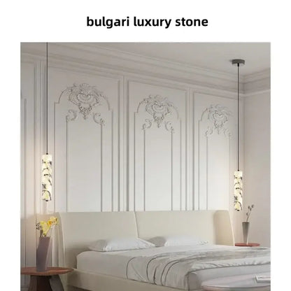 Bulgari luxury pendant light fixture with elegant marble stone cylindrical shades and sleek black cords by DecorBites™