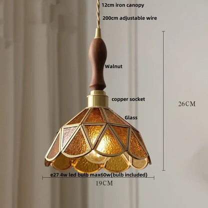Warm amber-tinted decorbites led pendant light with walnut wooden handle and brass accents for modern living spaces