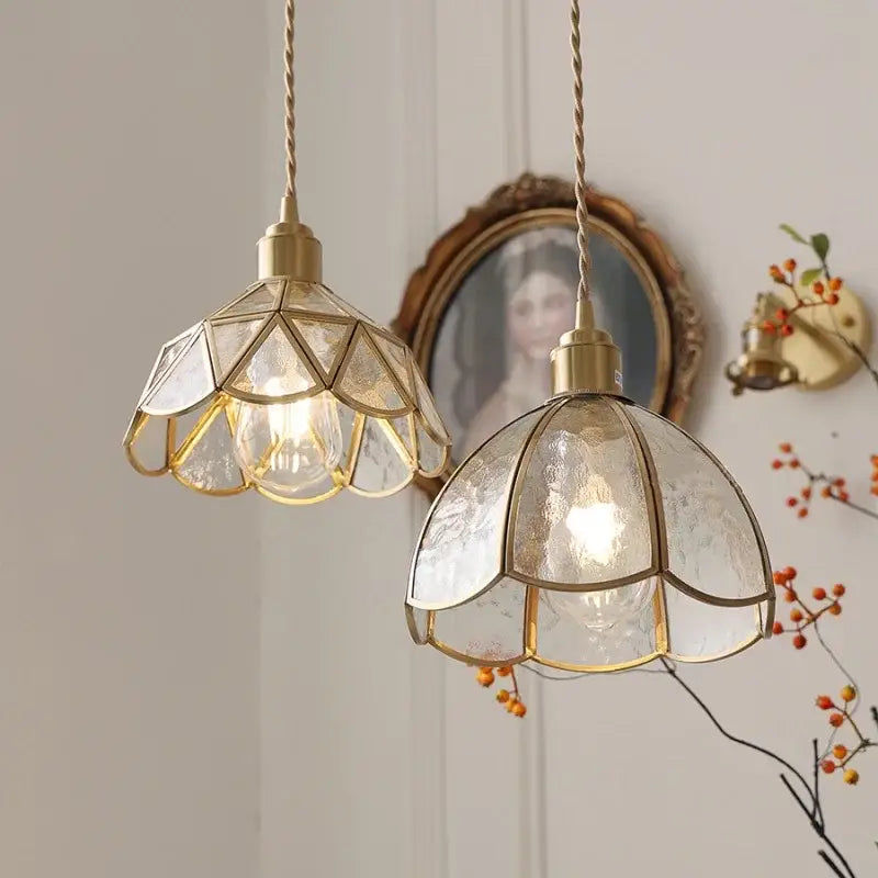 Two elegant brass-framed decorbites led pendant light fixtures with textured translucent glass shades for modern living room