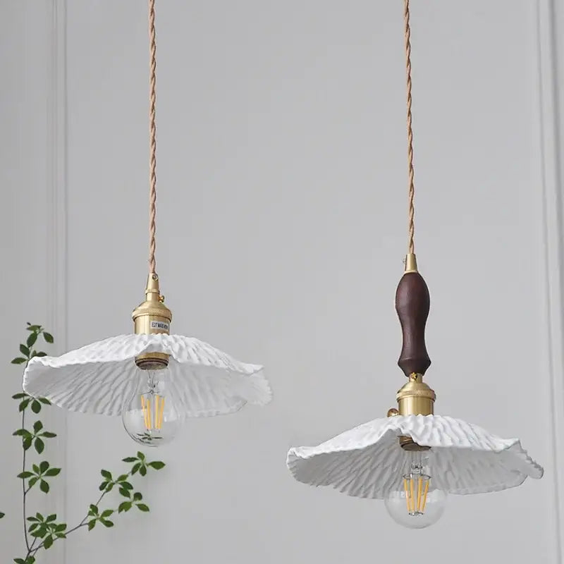 Two elegant white ceramic pendant lights with gold-toned hardware and twisted copper cords by DecorBites LED pendant light fixture