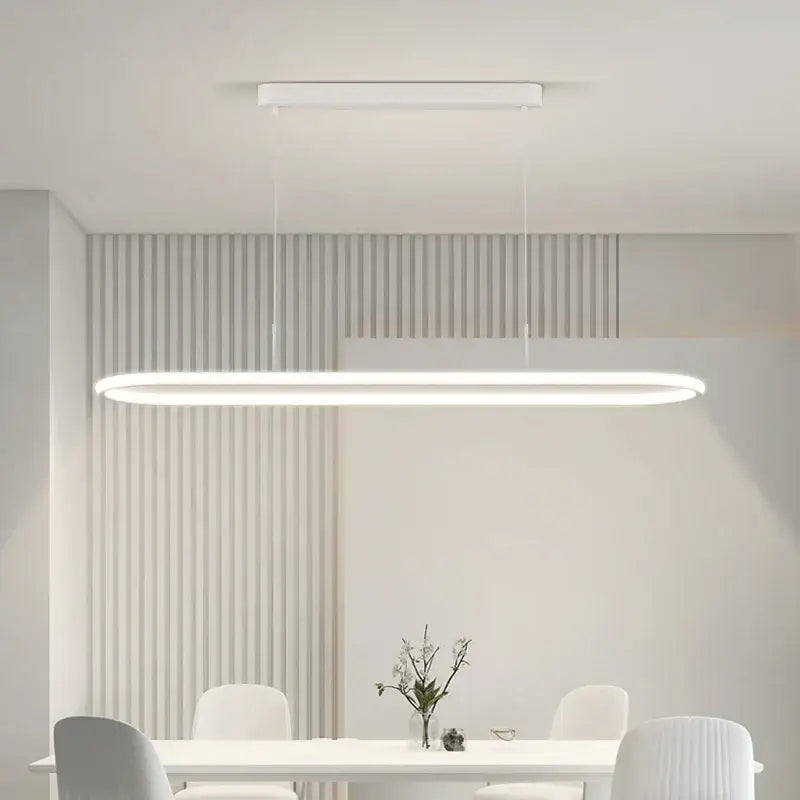 A sleek white rectangular DecorBites led pendant light with minimalist design hanging for dining and kitchen use