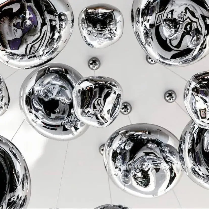Shiny chrome-finished spherical decorbites led pendant light with reflective distorted surfaces for indoor use