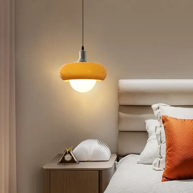 Warm yellow DecorBites LED pendant light with smooth glass shade and sleek metallic fixture for bedroom and dining room