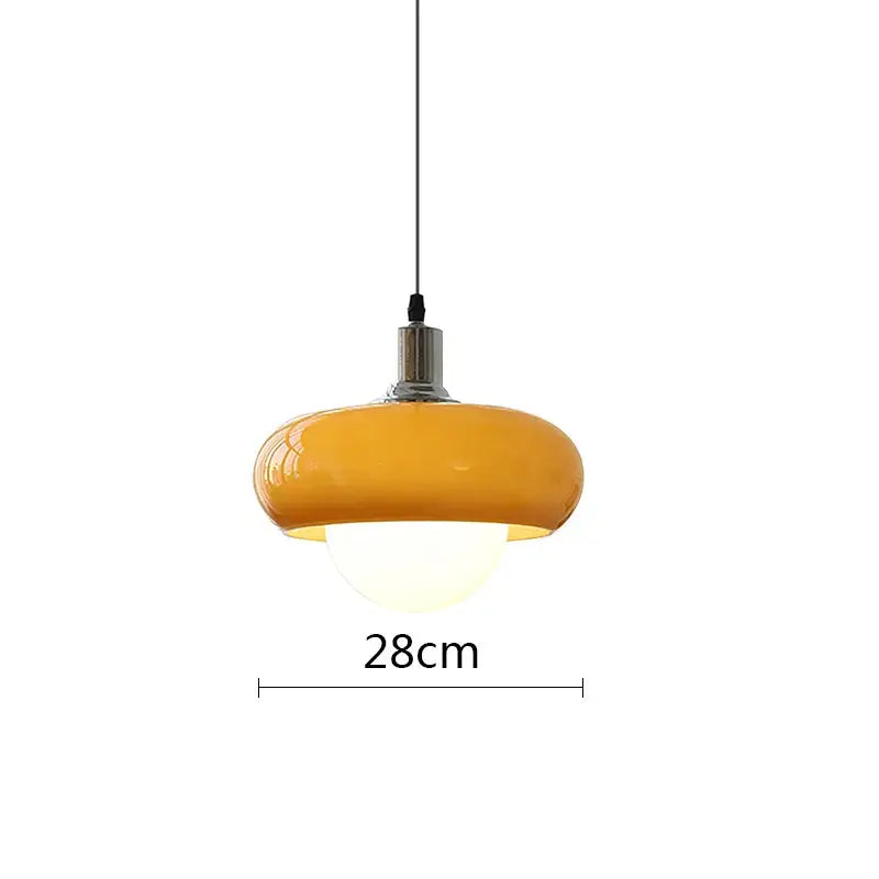 A warm amber glass decorbites led pendant light with rounded dome design and polished chrome fixture for modern spaces