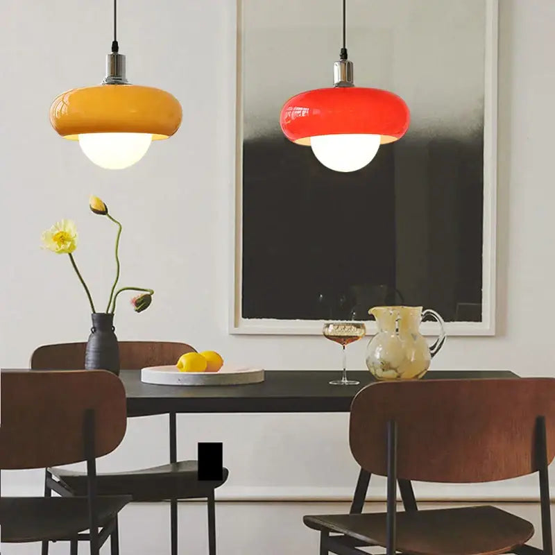 Two vibrant decorbites led pendant lights in orange and red with glossy finish and metallic fixtures for modern spaces