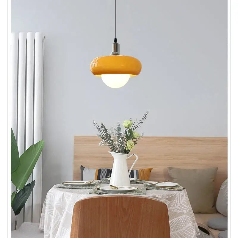Vibrant yellow DecorBites™ LED pendant light with glossy rounded glass shade and metallic fixture for modern rooms