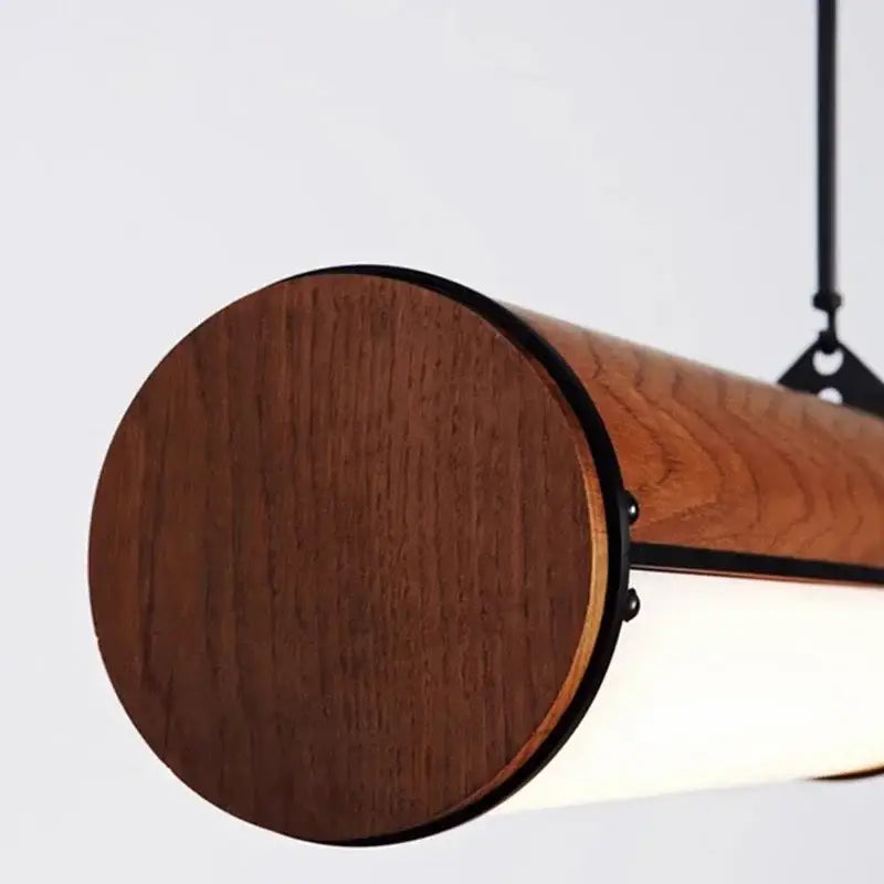 A sleek cylindrical wooden pendant light with rich brown finish and black metal accents by DecorBites led pendant