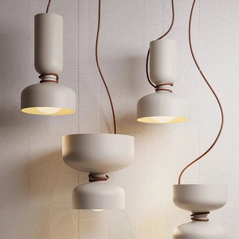 Modern off-white ceramic decorbites led pendant light with brown leather-wrapped cords and warm diffused glow