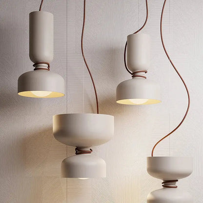 Modern off-white ceramic decorbites led pendant light with brown leather-wrapped cords and warm diffused glow