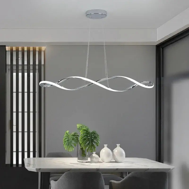 Modern chrome-finished DecorBites LED pendant light with a sleek wave-like design for living dining kitchen bar spaces