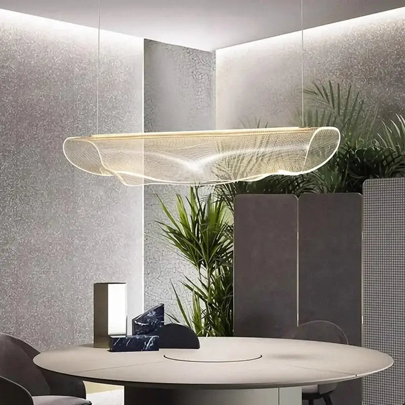 A modern translucent gold-toned decorbites led pendant light with wave design for living and dining room lighting