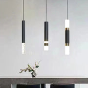 Three black matte cylindrical pendant lights with gold accents and frosted glass diffusers by DecorBites led pendant light