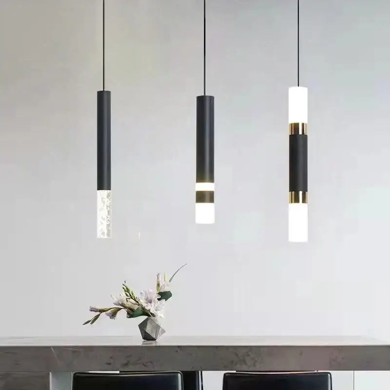 Three black matte cylindrical pendant lights with gold accents and frosted glass diffusers by DecorBites led pendant light