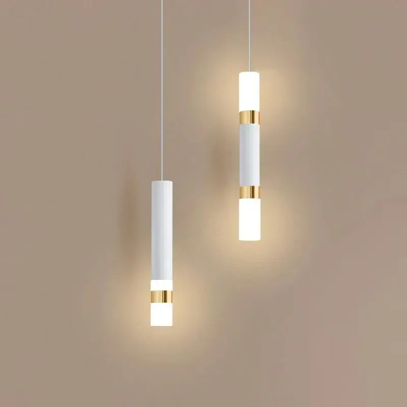 Two minimalist white cylindrical pendant lights with gold accents by DecorBites led pendant light for indoor decor