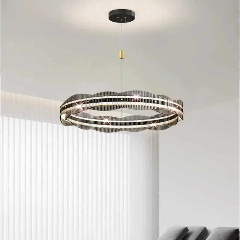 Modern black and gold ring-shaped decorbites led pendant light with sleek wavy design for living and dining spaces