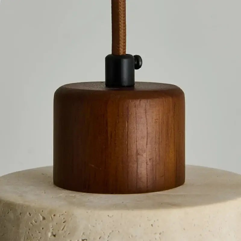 Warm-toned wooden cylindrical lamp base with black metal fitting and brown cord in decorbites led pendant light