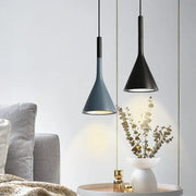 Two decorbites led pendant lights in matte black and muted blue-gray with conical shades for modern interiors