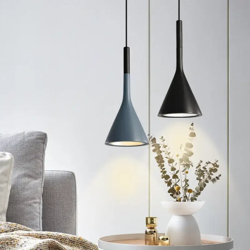 Two decorbites led pendant lights in matte black and muted blue-gray with conical shades for modern interiors